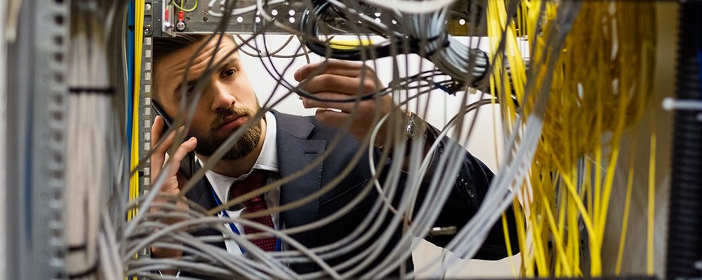 Telecom support Technician checking cables